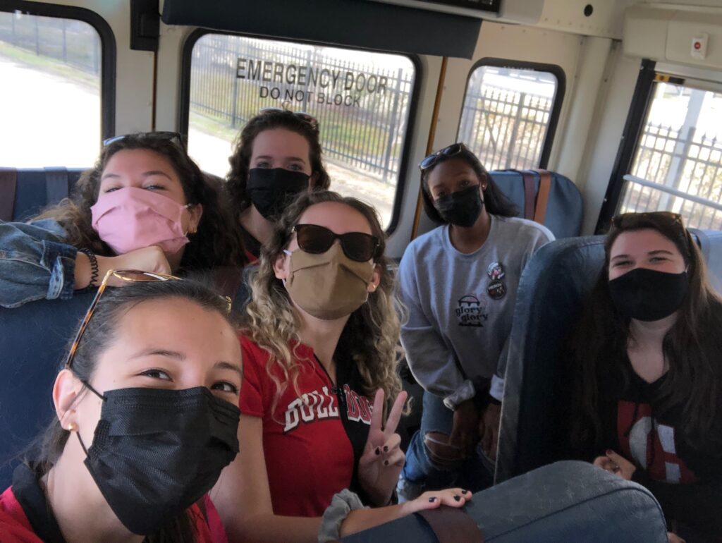 My friends and I wearing masks on a bus