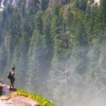 A person standing at the edge of a cliff