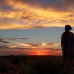 A person looking at a sunset