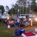 People gathered in lawn chairs